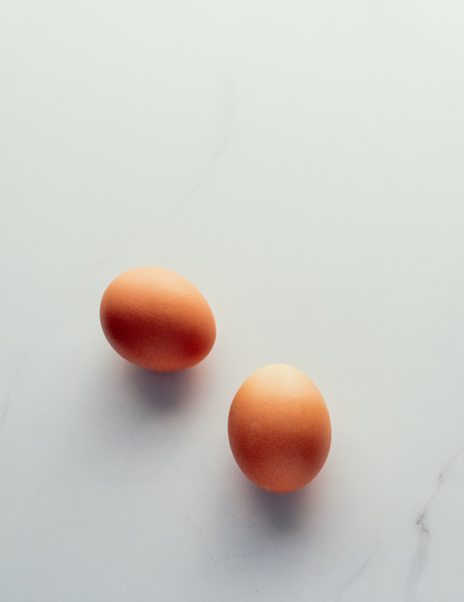 Egg on marble table as minimalistic food flat lay, top view food